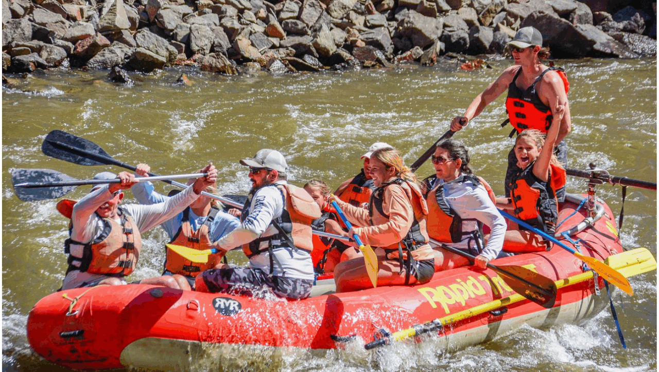 Family rafting under golden aspen trees on Big Thompson River in fall - Colorado mountain reflections, autumn colors, and gentle rapids with Rapid Transit Rafting near Estes Park