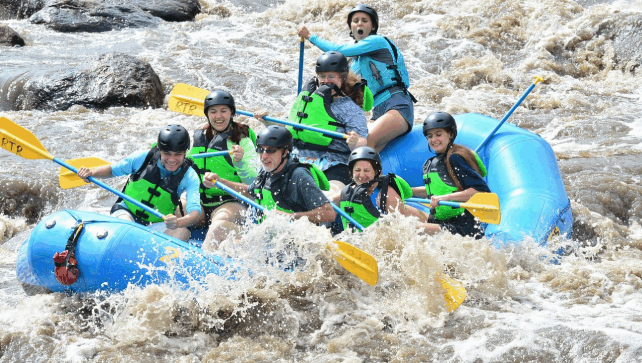 Happy family with children rafting on Big Thompson River near Estes Park, Colorado - gentle rapids, safety gear, and mountain views
